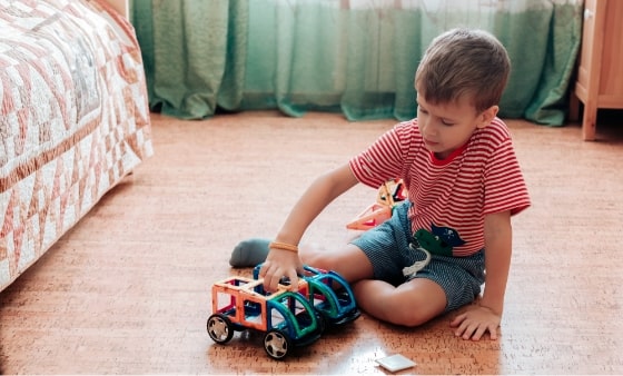 child playing on floor with toys