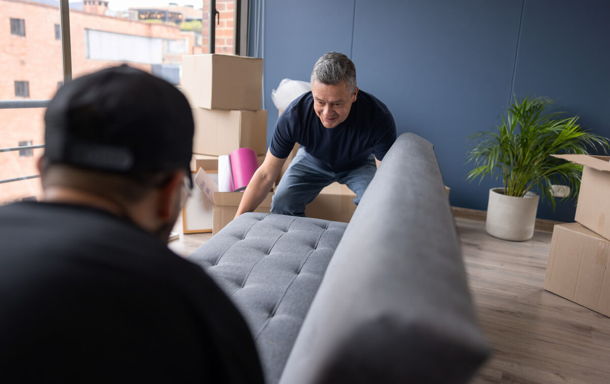 2 men moving a couch image