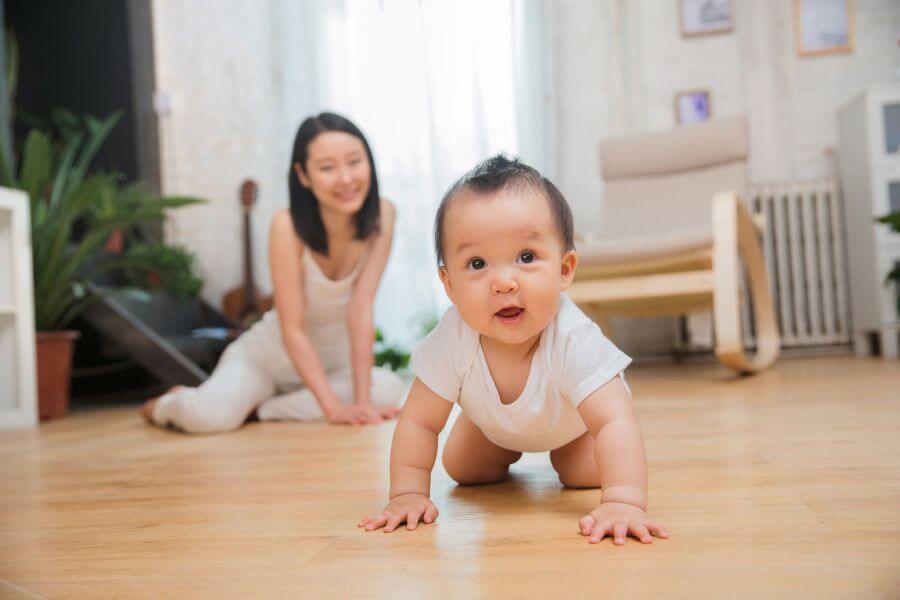 Mother and baby on a wood floor room image