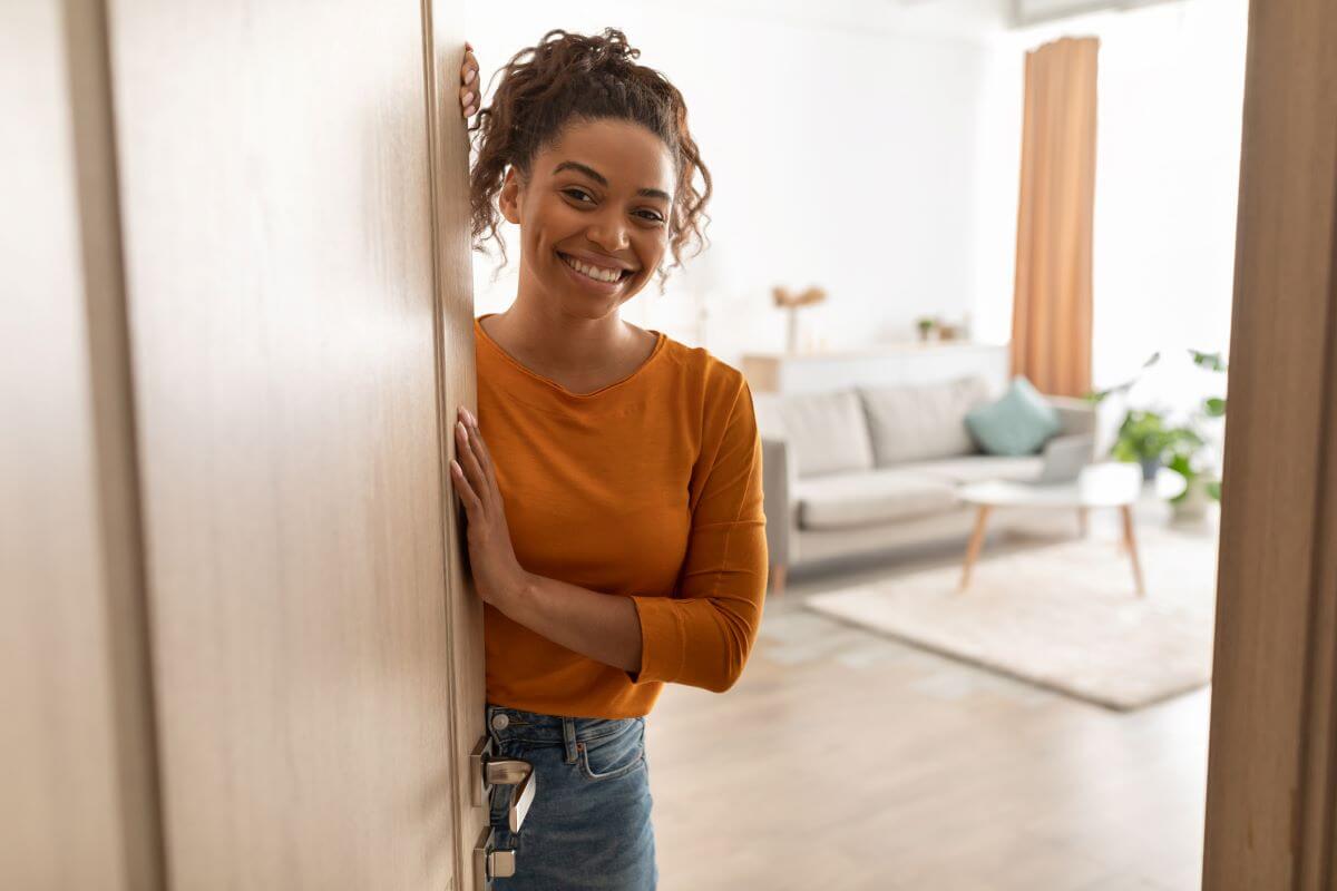 Woman standing at door with living room behind her image