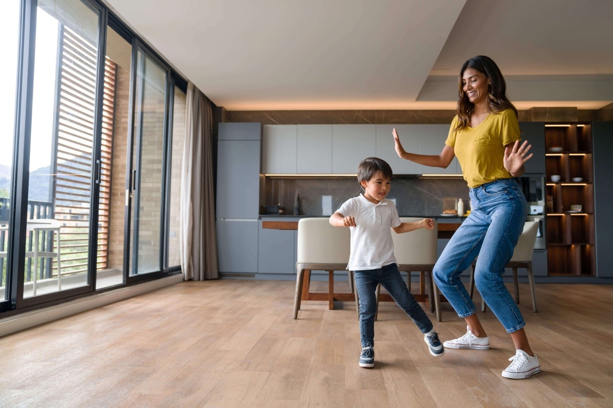 mother and son dancing on floor