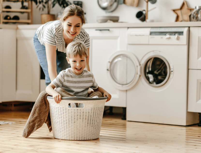 mom and son playing in laundry room